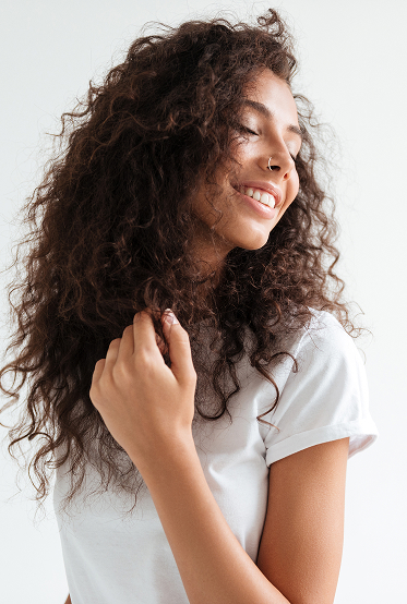 chica morena de pelo rizado sonriente